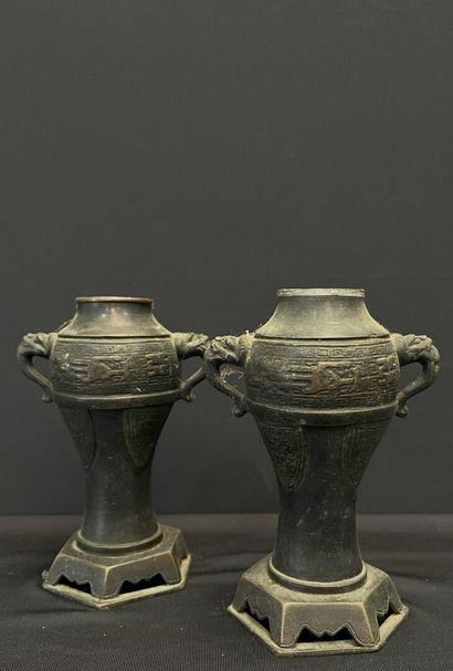 null CHINA - Late 19th century. 
GARNITURE comprising: two baluster vases, side handles...