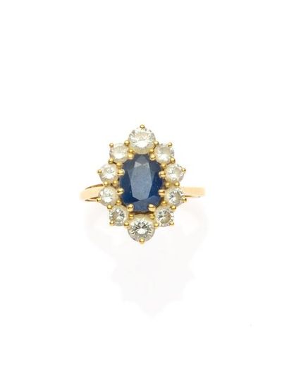 null 750MM yellow gold ring decorated with an oval sapphire in a row of ten diamonds,...