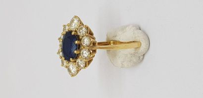null 750MM yellow gold ring decorated with an oval sapphire in a row of ten diamonds,...