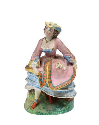 null PARIS
Figurine en biscuit polychrome représentant une élégante à robe rose et...