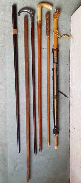 null Set of two canes, one with a horn knob, the other with a blade. Exotic wood...