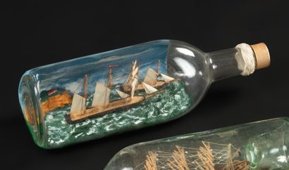 null Bottle containing a marine diorama composed of a seaside decoration, cliffs,...