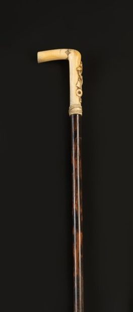 null Cane with ivory knob decorated with basketry attributes, shaft in exotic wo...