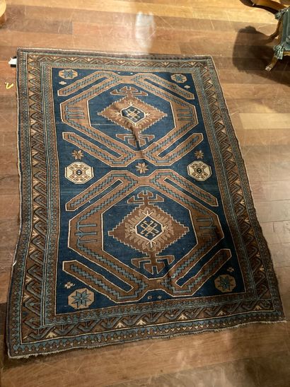 null Caucasus Carpet with brown geometric decoration on a blue background (wear)

130...