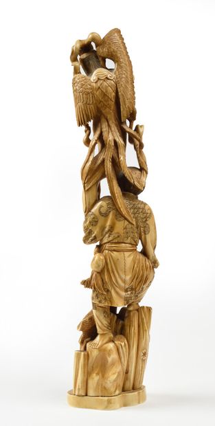 null JAPANese carved ivory okimono representing a fisherman resting on a rock topped...