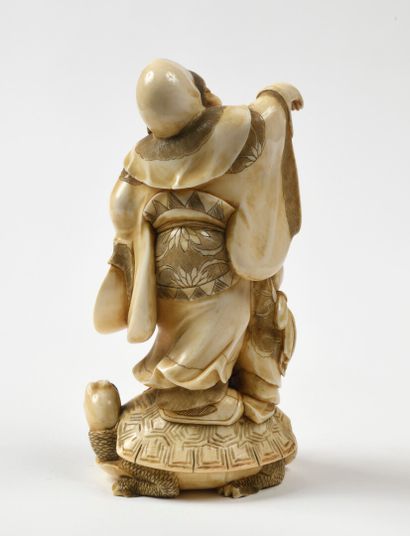 null JAPANese carved ivory okimono representing a character and a child, perched...