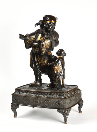null A JAPANese bronze group with a brown patina and a gold niello representing a...
