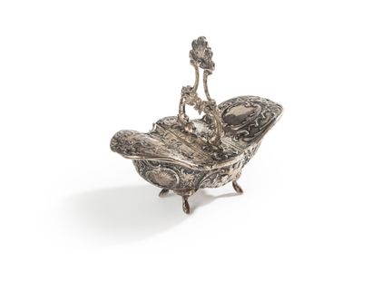null A silver oval double saltcellar on four feet, with rocaille repoussé decoration,...