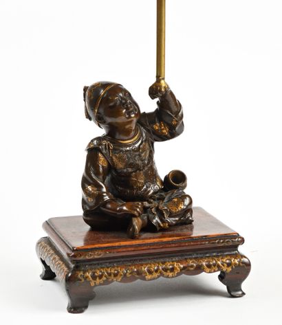 null JAPAN, Miyao style, bronze figurine with gold niel representing a seated child....