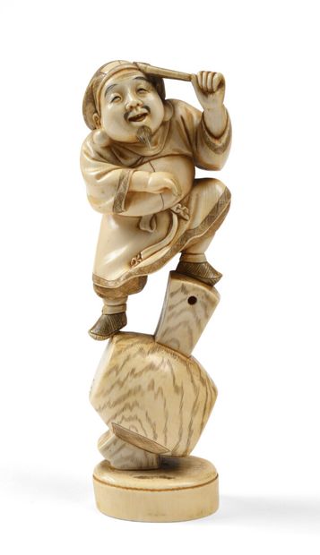 null JAPANese carved ivory Okimono representing Daikoku perched on a mallet. Red...