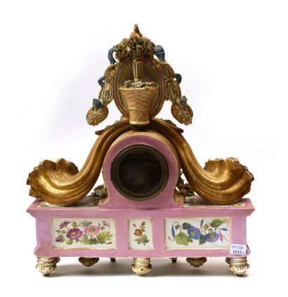 null PARIS ATTRIBUTED TO JACOB PETIT Porcelain clock resting on 9 feet decorated...