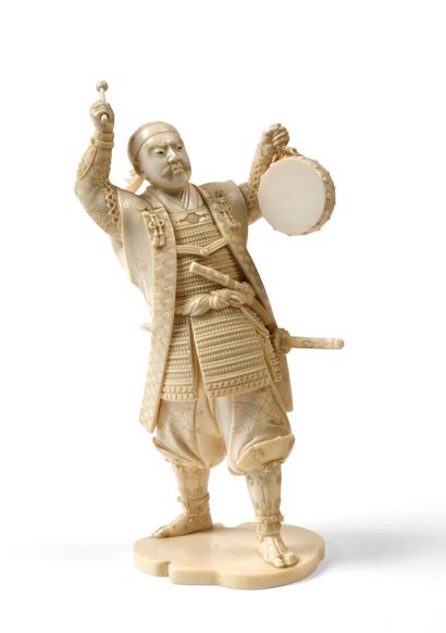 null JAPAN Carved ivory figurine representing a samurai playing tambourine, standing...