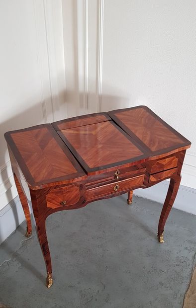 null A rosewood and amaranth veneer dressing table opening with two drawers and a...