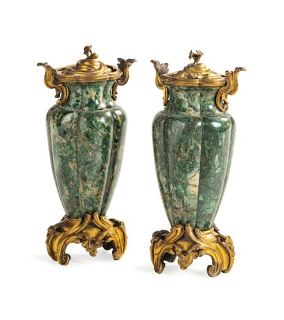 null A pair of green veined hardstone simulated vases with a wide ribbed body; the...