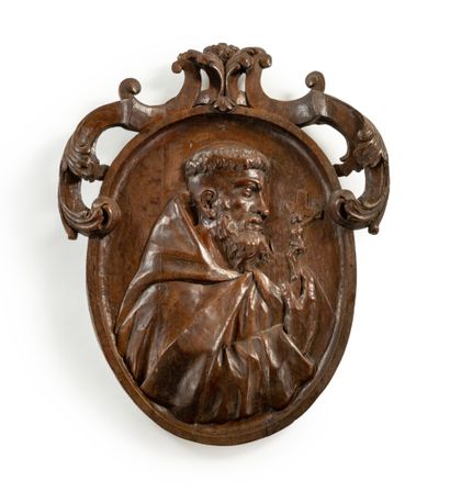 null A molded and carved wood medallion underlined by crosses and acanthus; of oval...