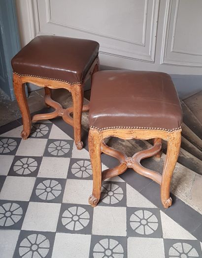 null Pair of stools in molded and carved natural wood, with scrolled legs and x-shaped...