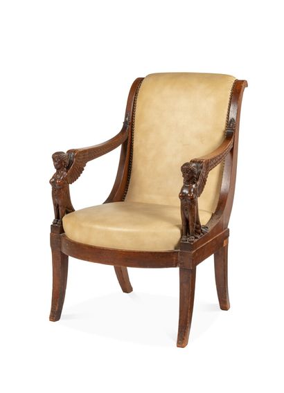 null A mahogany and mahogany veneer armchair with a slightly overturned backrest;...