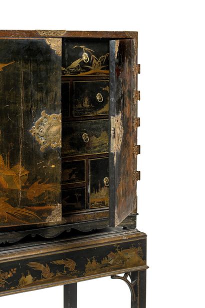 null Small cabinet decorated in imitation of Japanese gold lacquers on a black background...