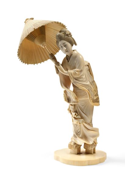 null JAPAN Large carved ivory figure of a standing Bijin holding an open parasol....