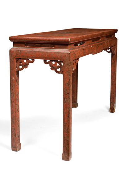 null CHINA - 17th century

A red and brown lacquered wood console decorated with...