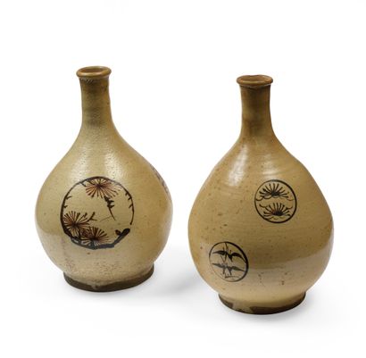 null JAPAN Two stoneware sake bottles with beige background, decorated in copper...