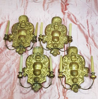 null Suite of four two-light sconces in carved and gilded wood ; the scrolled plates...