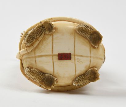 null JAPANese carved ivory okimono representing a character and a child, perched...
