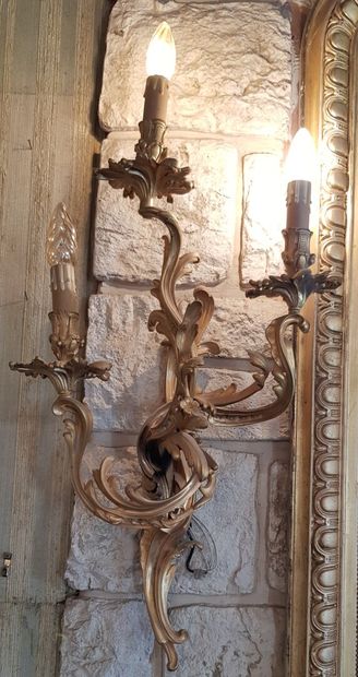 null A pair of ormolu sconces in the rocaille style with three lights 

Height :...