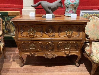 null Provencal chest of drawers in natural wood, molded and carved with scrolls and...