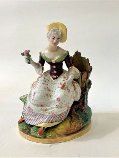 null Pair of polychrome porcelain groups featuring a young girl with a rose and a...