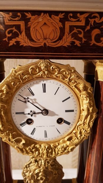 null Portico clock in marquetry of light wood foliage on mahogany background.
Dial...