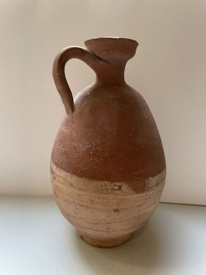 null Set of two jugs and a balsamaire.
Ochre terracotta. 
Egypt? Greek and Roman...