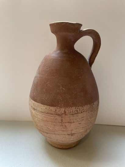 null Set of two jugs and a balsamaire.
Ochre terracotta. 
Egypt? Greek and Roman...