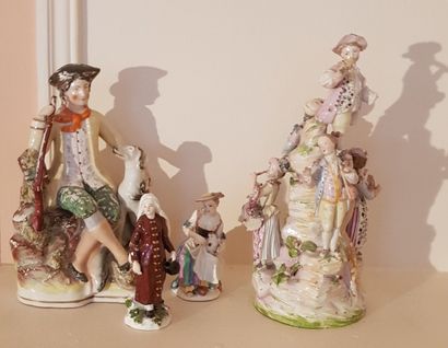 null Four polychrome porcelain groups featuring a child musician on a mound, a hunter...