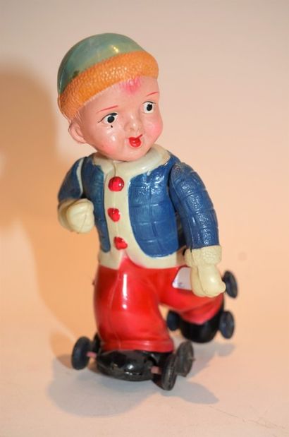 null Mechanical toys (2) :

sheet metal clown dressed in cloth raising his hat (E)...