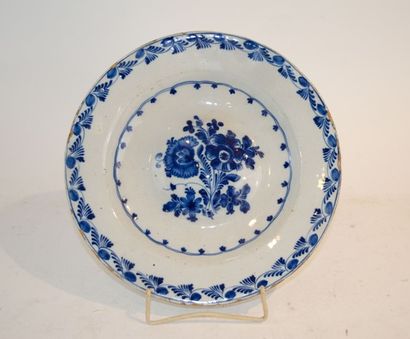 null 18th century Delft dish with blue monochrome decoration with a floral bouquet...