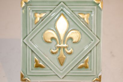 null Set of approximately 250 glazed ceramic tiles with a golden fleur-de-lys motif...