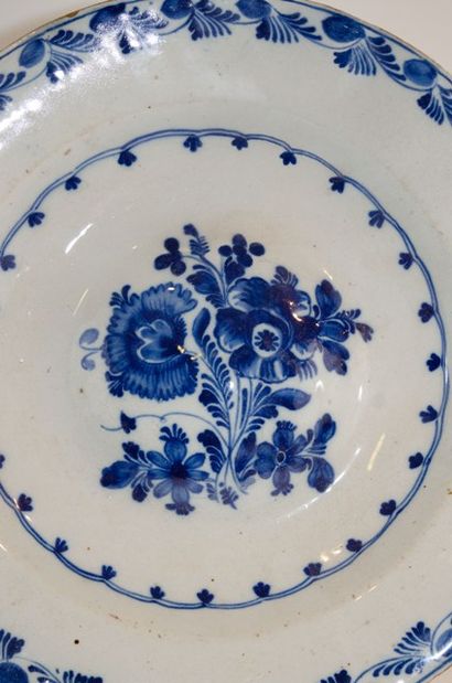 null 18th century Delft dish with blue monochrome decoration with a floral bouquet...
