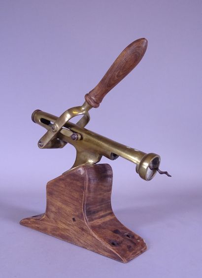 null Object: Large wall-mounted corkscrew in bronze with golden patina on a wooden...
