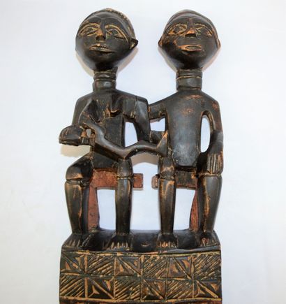 null Ivory Coast: carved wooden comb representing a couple with a nursing child....