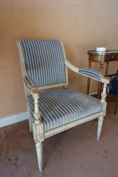 null White painted wooden armchair, backrest slightly upside down
Blue striped velvet...