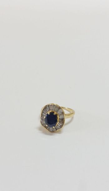 null Ring in 750 thousandths yellow gold set with an oval sapphire in a skirt setting...