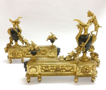 null Pair of patinated bronze and gilt bronze andirons decorated with ewer and goat,...