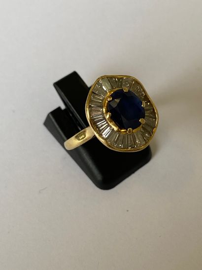 null Ring in yellow gold 750 thousandths decorated with an oval sapphire in an entourage...