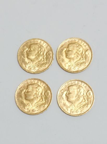 null Quatre pièces dont : 



Trois pièces de 20 Francs Suisse or 1935, 

une pièce...