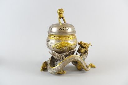 null A partially gilded pewter incense burner decorated with a dragon and a dog

Height...