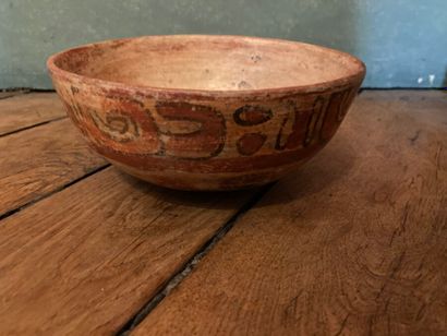 null Ceremonial bowl with glyph decoration

Brown terracotta with red, orange and...