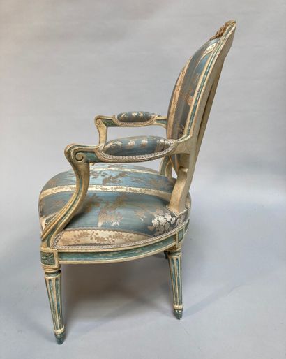 null A suite of four repainted beechwood armchairs with a cabriolet medallion backrest,...