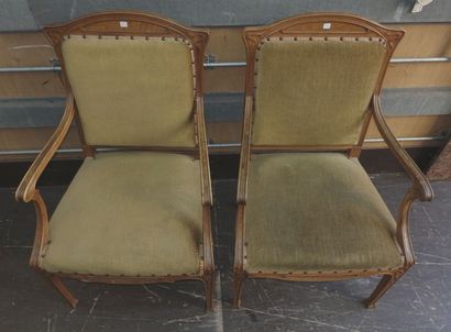 null A pair of carved moulded walnut armchairs with straight backs and hollowed out...