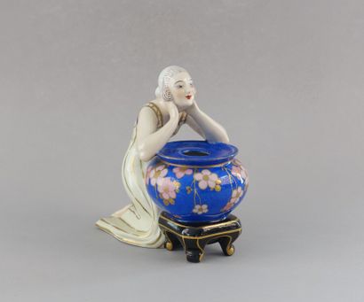 null Ceramic subject representing a woman kneeling and leaning on a blue vase.

Marked...